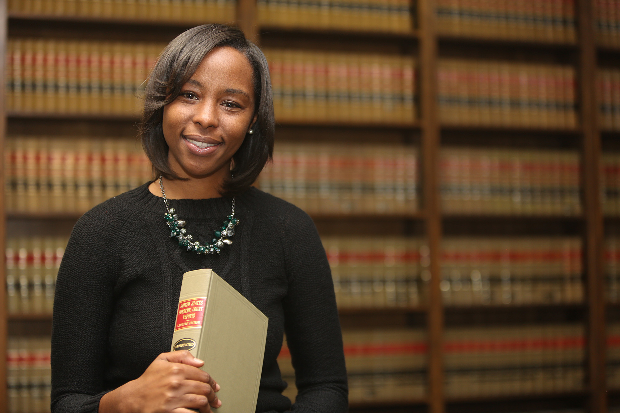 Woman holding law book city attorneys